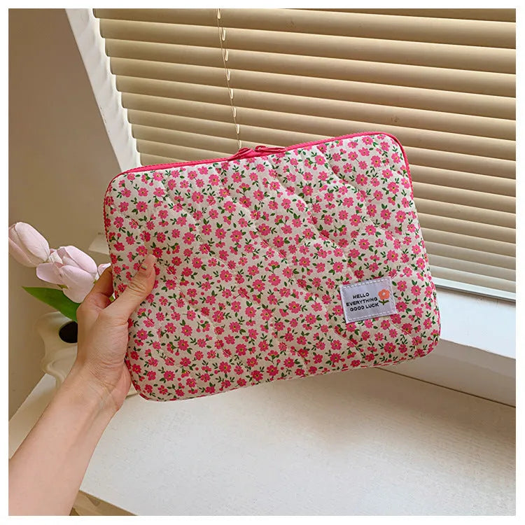 Green floral print cloth laptop bag showing front storage pocket and slim 3cm depth profile.