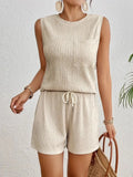 Women's apricot sleeveless vest and matching shorts set laid flat, solid colour polyester fabric.
