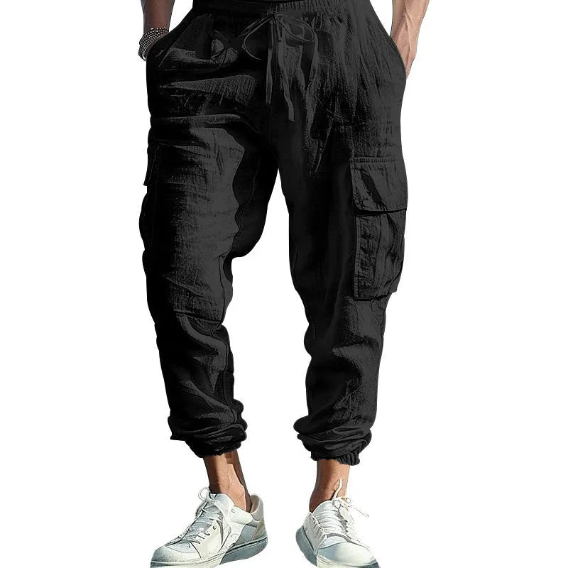 Men's loose-fit linen casual trousers with ankle-tied cuffs and multiple pockets in a solid colour.