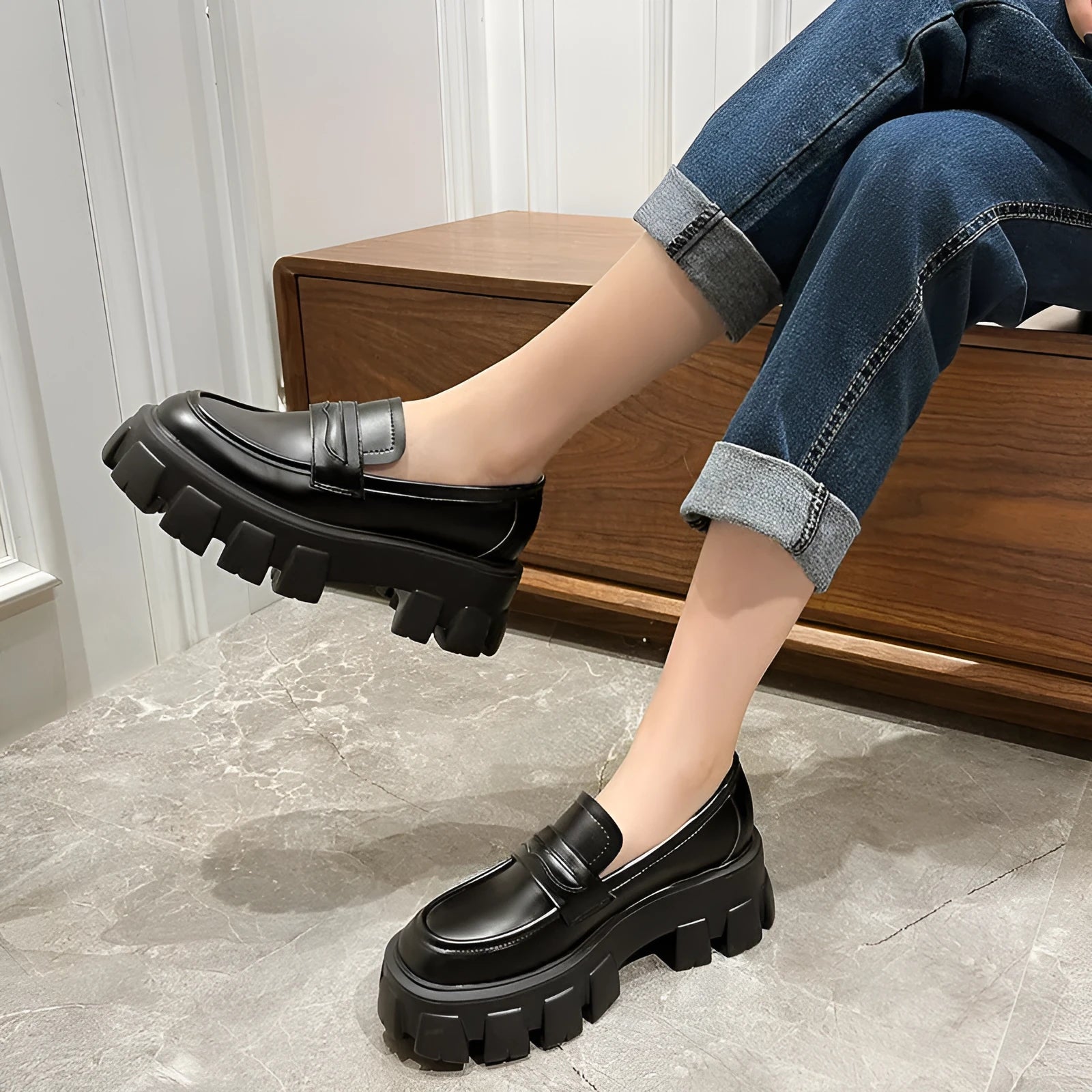 A pair of British style wide fit loafers with a muffin heel, shown in patent leather and matte colour options.