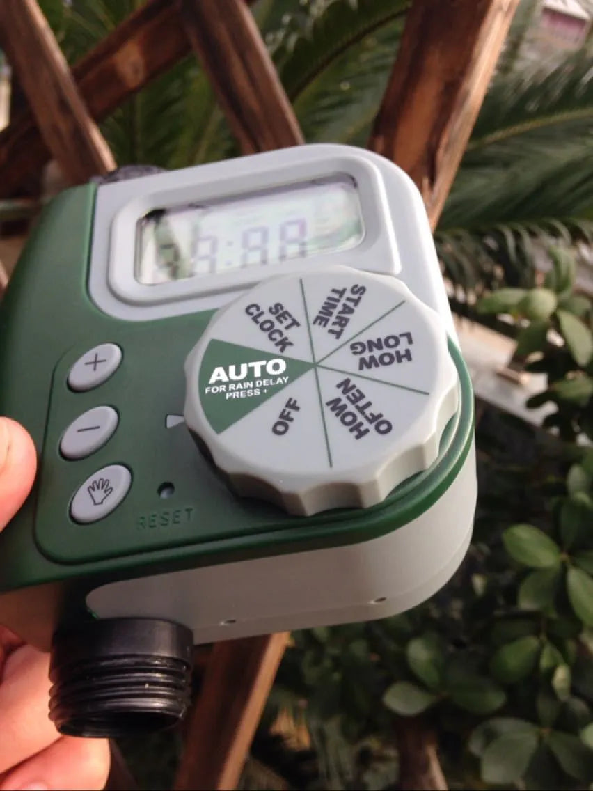 Green programmable digital hose timer with copper faucet connector and large digital display for automatic garden watering