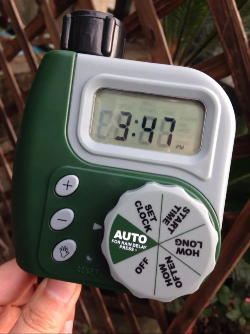 Green programmable digital hose timer with copper faucet connector and large digital display for automatic garden watering