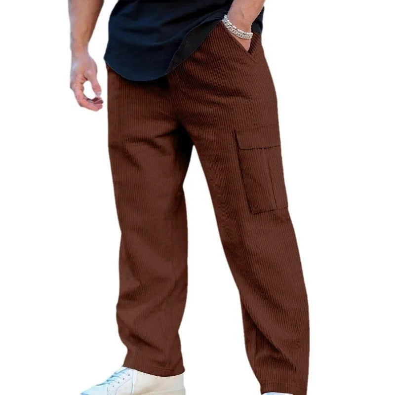 Men's navy blue corduroy cargo trousers with wide-leg design and drawstring waist laid flat.