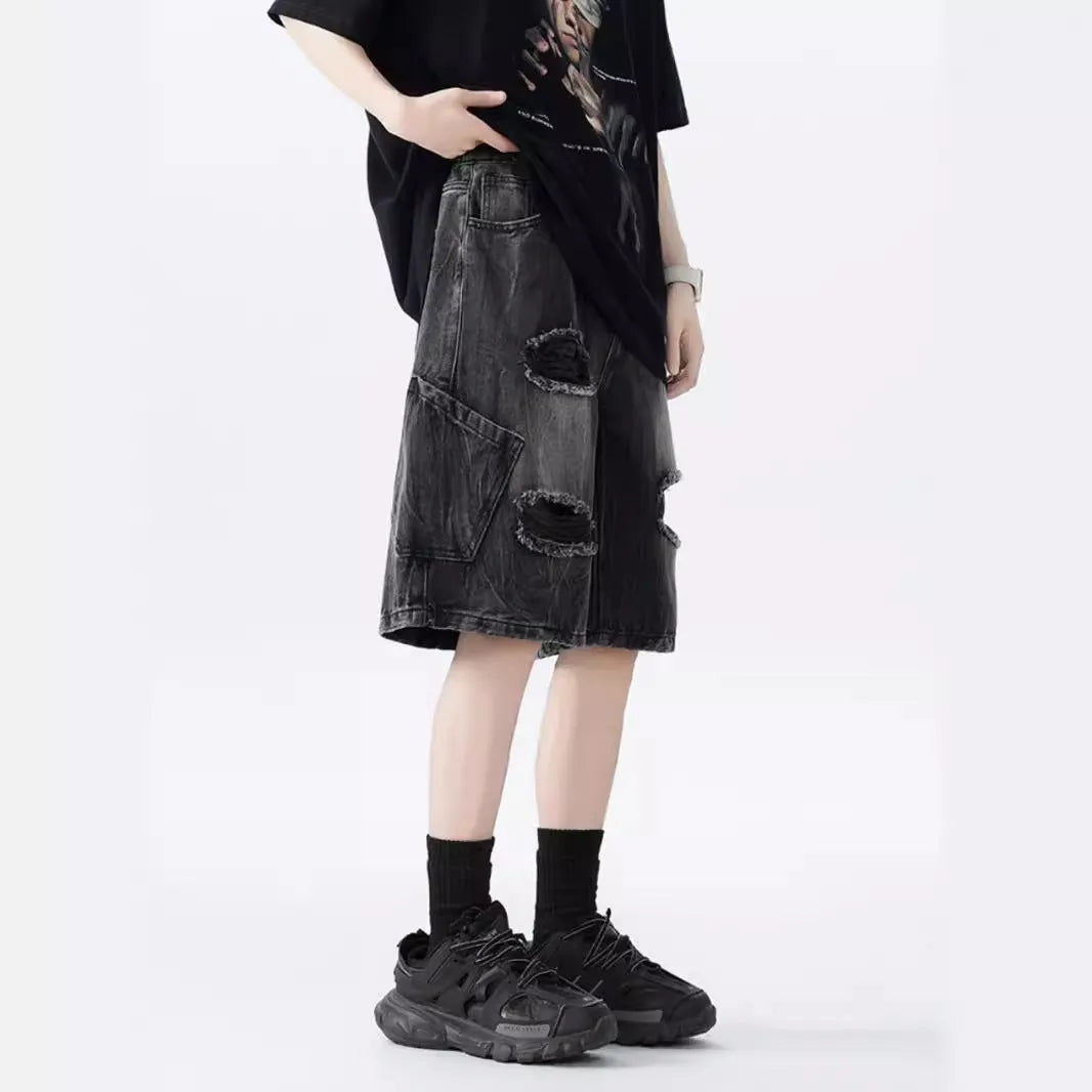 Men's ripped denim shorts with washed finish in black and blue colours showing loose fit design