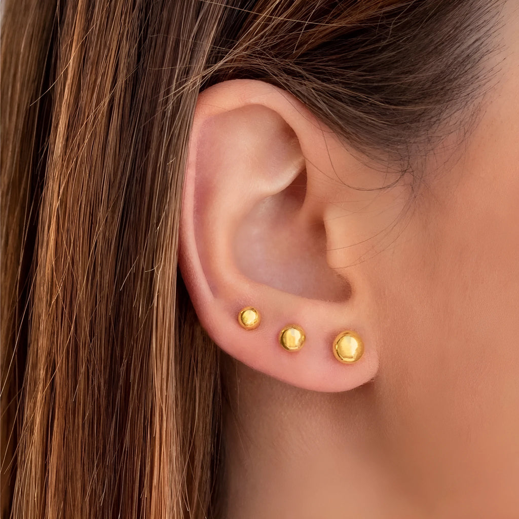 Stainless steel ball stud earrings in gold and silver tones showing 3mm to 6mm size variations
