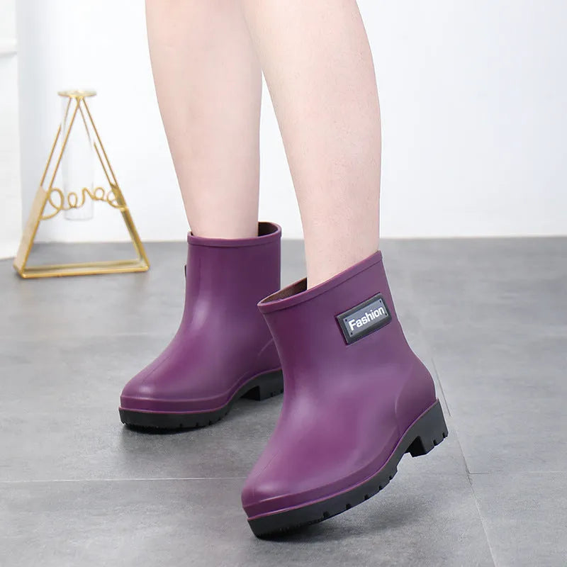 Women's PVC rain boots in black with mid-calf height and low heel design