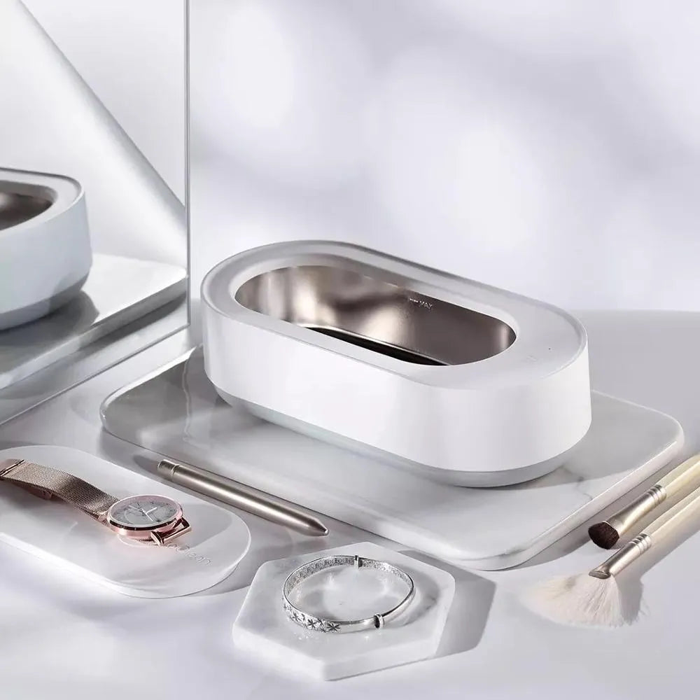 White portable ultrasonic cleaner with digital display and stainless steel cleaning tank.