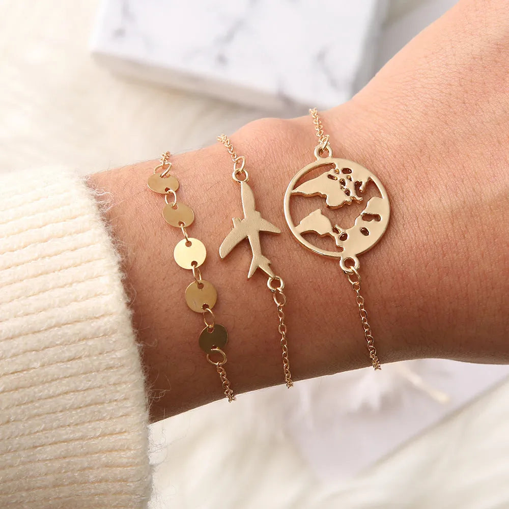 Set of three women's alloy bracelets with heart-shaped aircraft map charms.