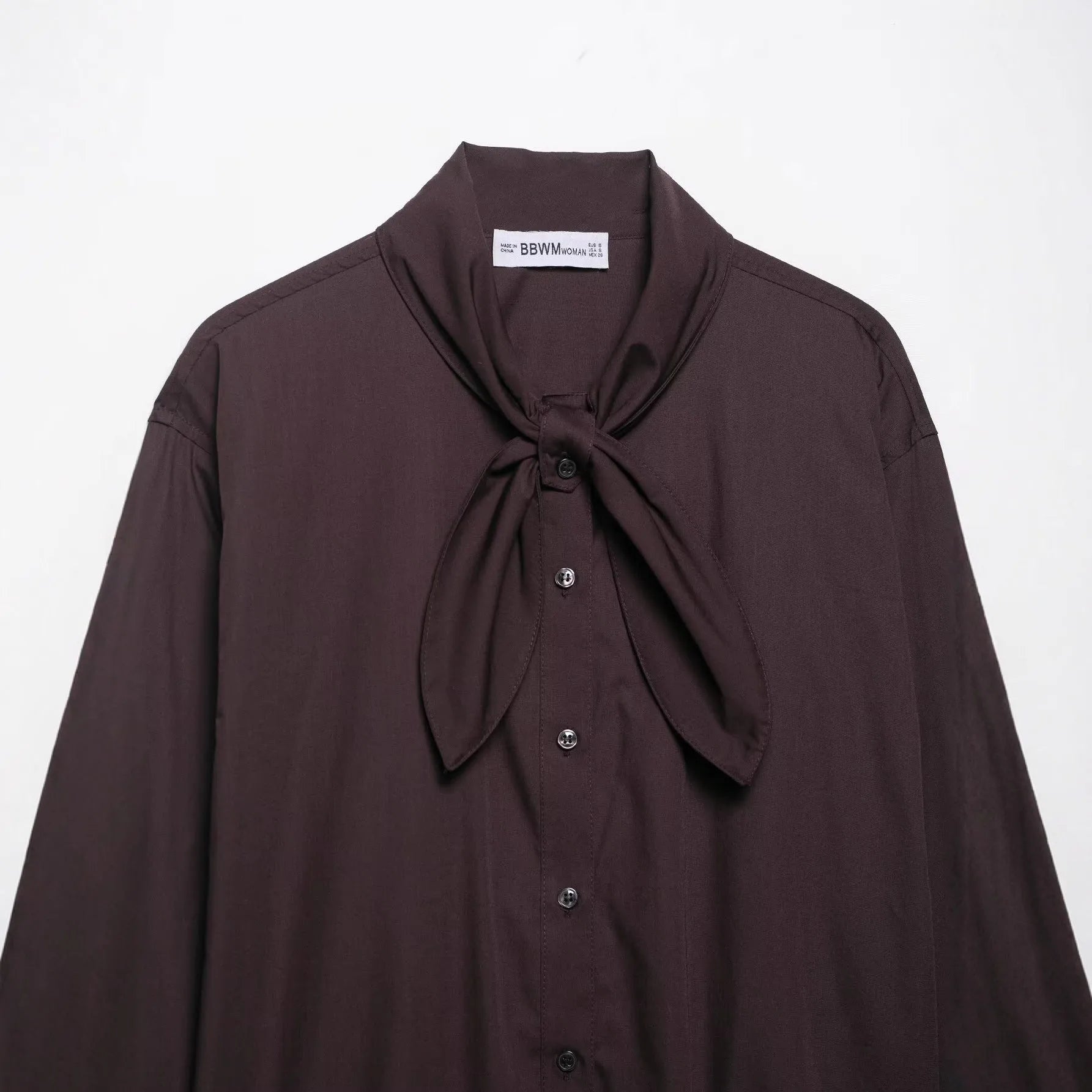 Brown women's poplin shirt with a loose fit, long sleeves, and a self-tie bow scarf collar.