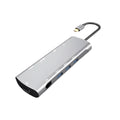 Grey aluminium USB-C docking station showing HDMI, VGA, USB 3.0, and USB-C PD ports with a short attached cable.