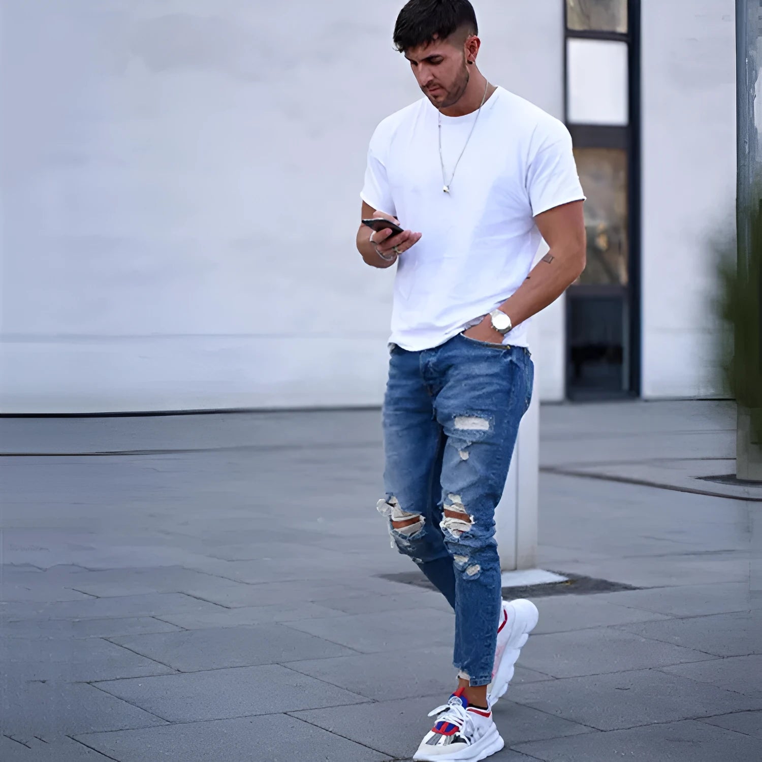 Men's deep blue cotton jeans with distressed hole details on the legs