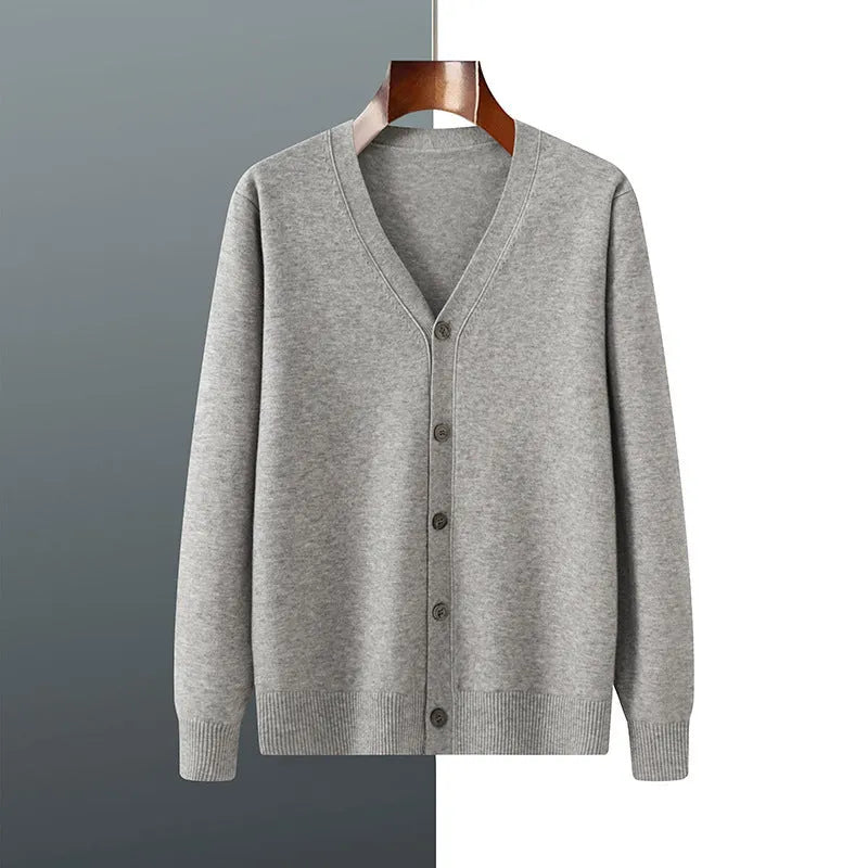 Man wearing a beige Andy velvet V-neck cardigan coat with long sleeves in a loose fit.
