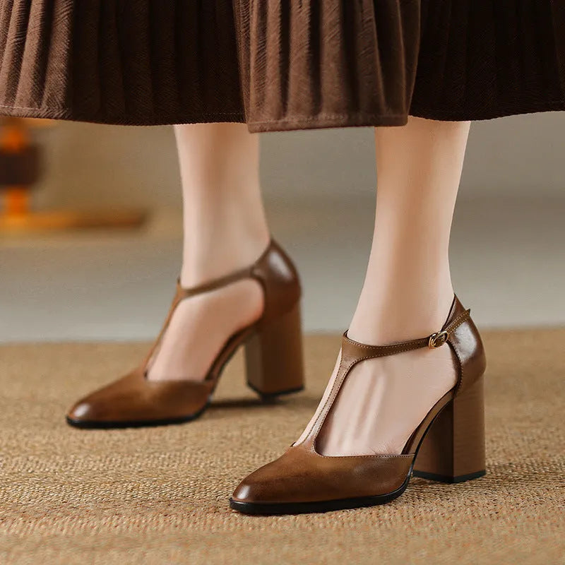 Women's dark brown retro Mary Jane shoes with a pointed toe, hollow Baotou detail, and buckle fastening.