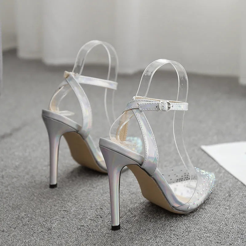 Women's pointed toe stiletto sandals with crystal diamond embellishment on the PVC upper.