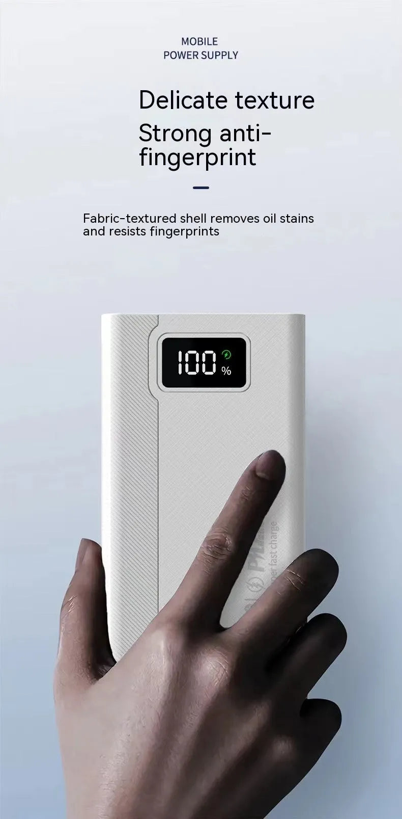 Black and white large capacity power bank with fast charging support, showing size scale.