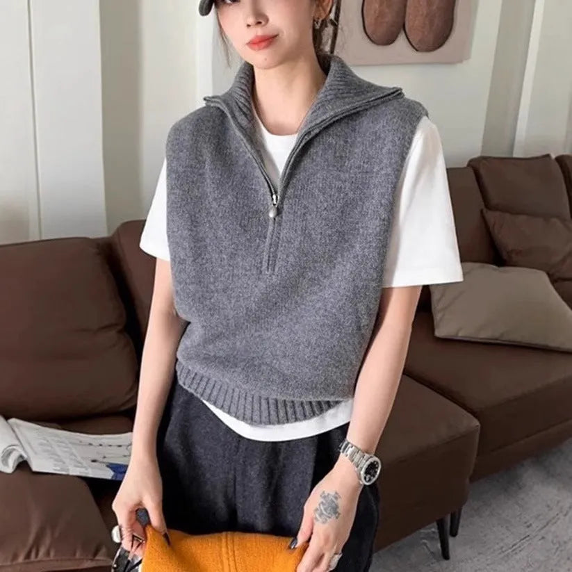 Woman's sleeveless half-zip knit vest with a 3D textured pattern in a solid colour.
