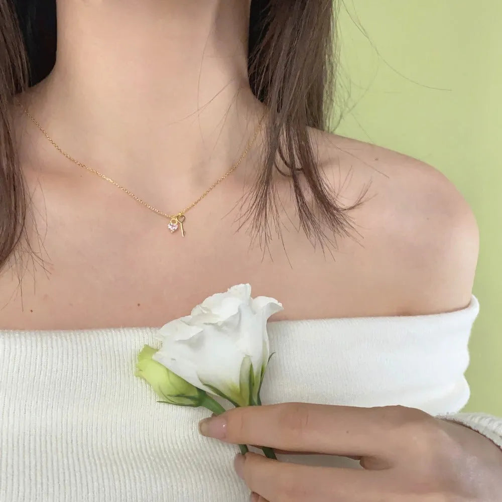 925 sterling silver heart-shaped key pendant necklace in gold finish on display