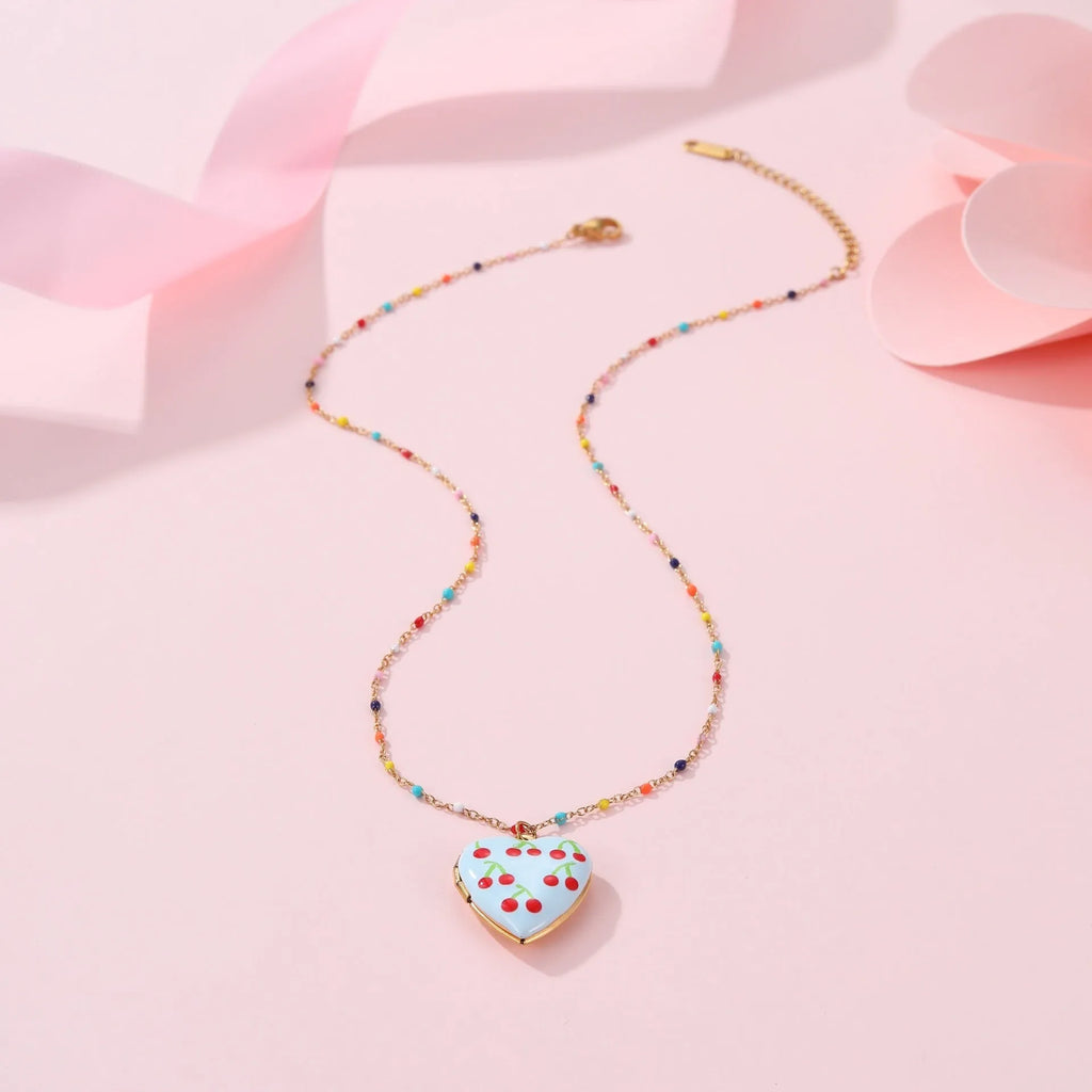 Stainless steel necklace with gold plated heart pendant featuring fruit design on adjustable chain