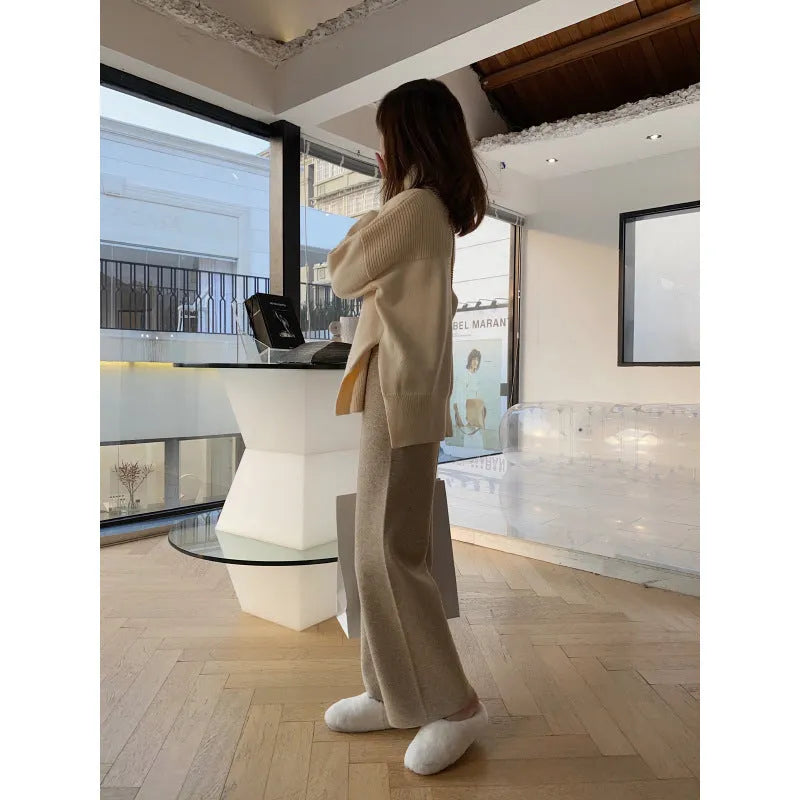 Women's cream white knitted wide-leg high-waist trousers laid flat, showing long straight-leg mopping style.