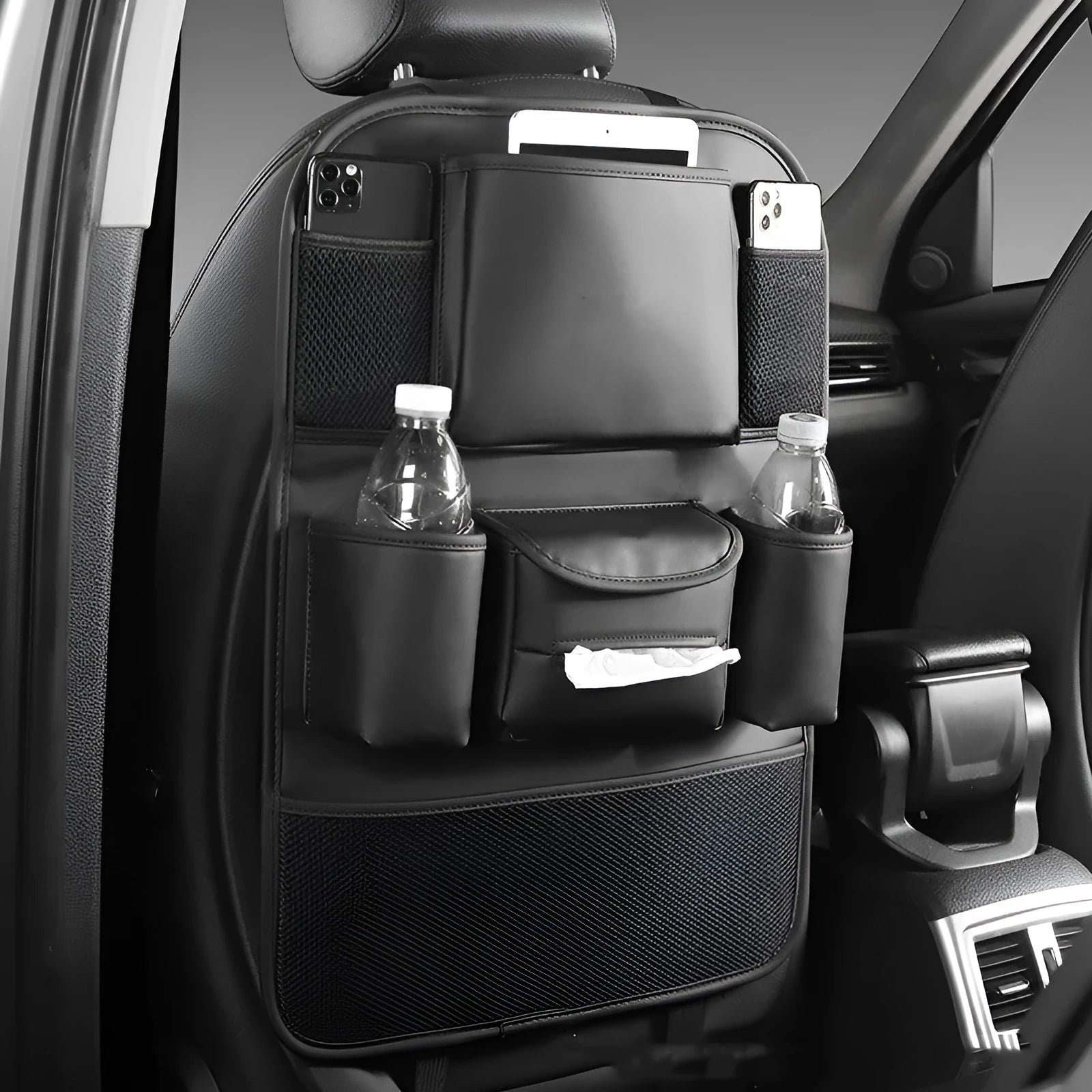 Black leather car seat back storage bag hanging on a vehicle seat.