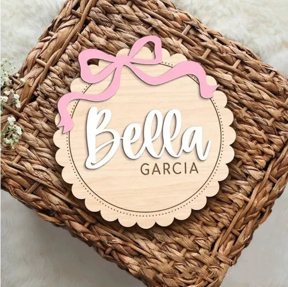 Customisable square wooden baby room ornament with a name, shown in two size options.
