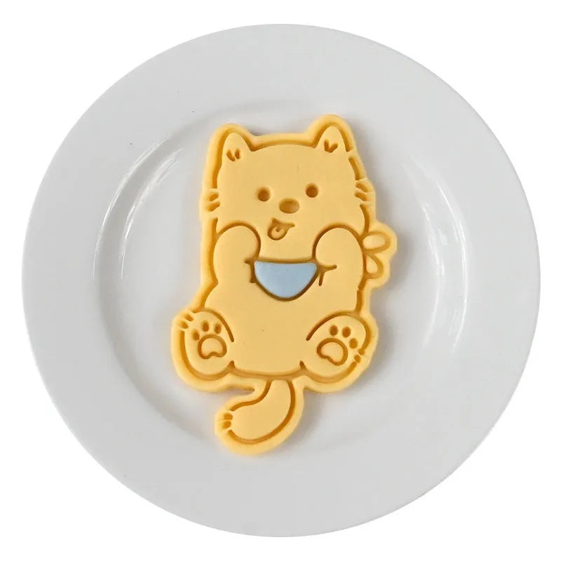 Plastic biscuit mould with puppy cartoon designs including birthday hats and swimming rings