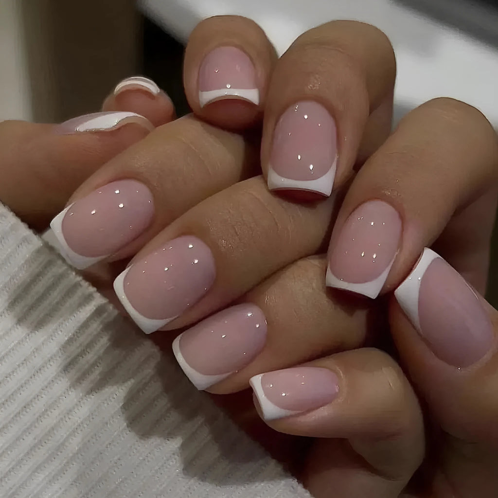 24 white acrylic nail tips with plaid pattern design arranged on display