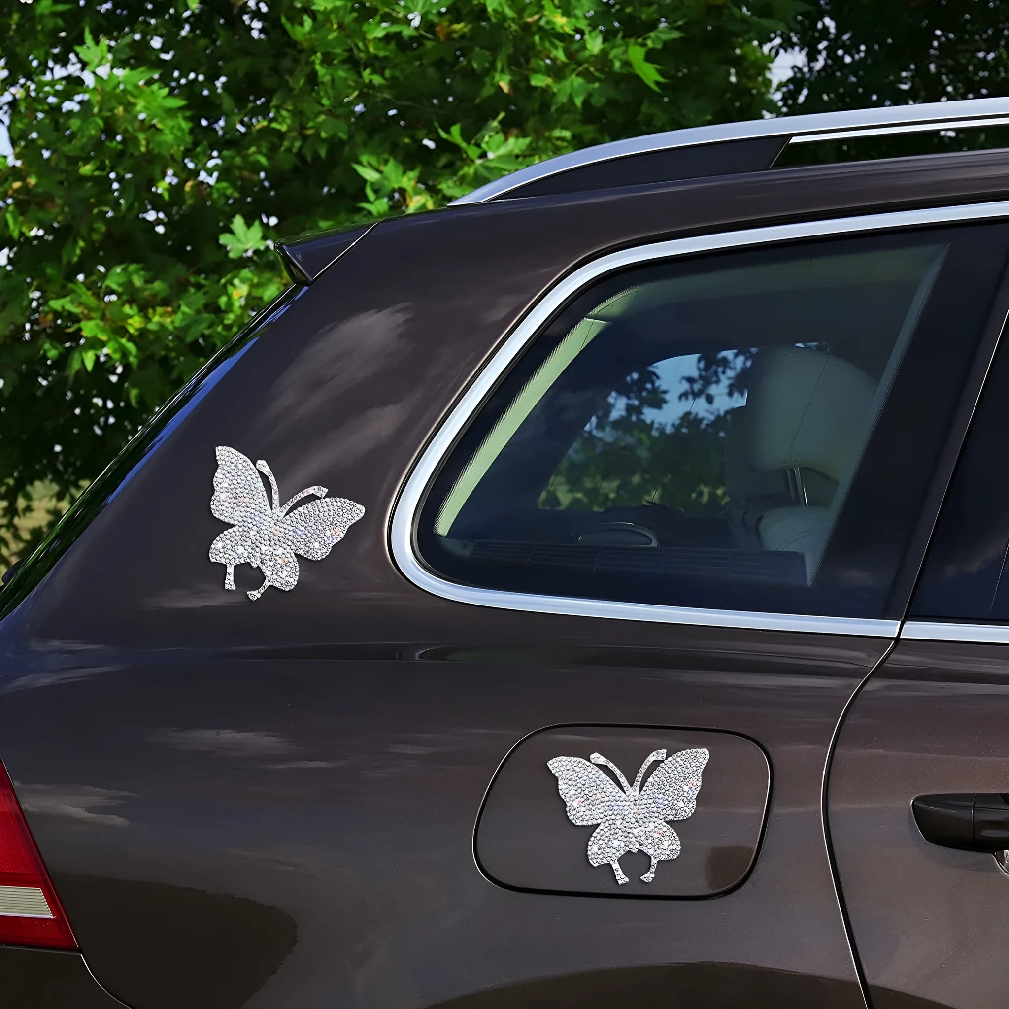 Glass car sticker with diamond-encrusted butterfly and bear paw design, 7cm by 6cm.