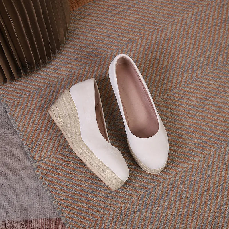 Women's wedge heel pumps with rope-wrapped bottom in apricot colour showing shallow open toe design