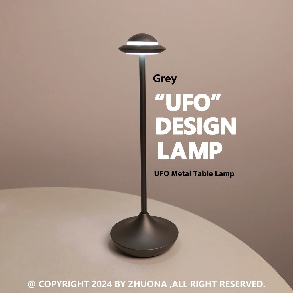 Modern creative UFO-shaped metal desk lamp with touch controls in black, gold, or grey finish.