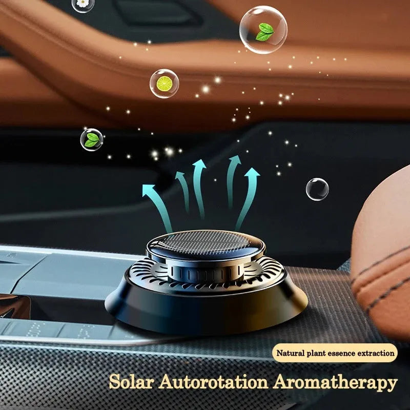 Solar-powered kinetic car air freshener with rotating double rings on a black plastic base.