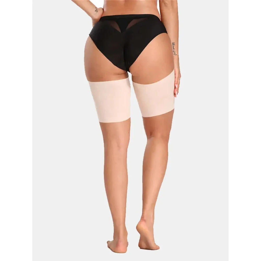 Women's anti-friction silicone thigh strap in black with adjustable nylon band on plain background