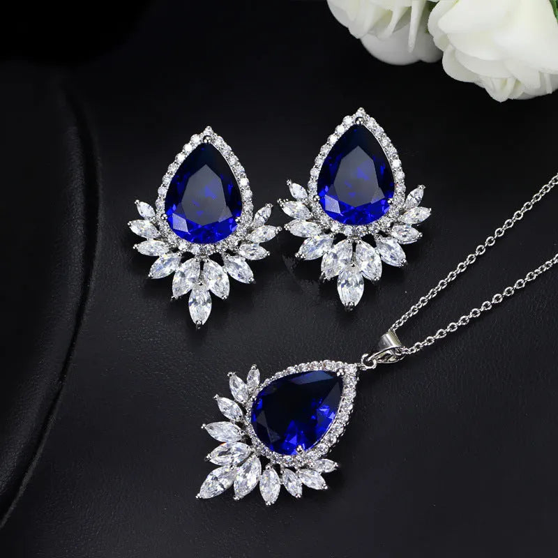 AAA formal jewellery set with necklace and earrings featuring cubic zirconia stones and crystal accents in blue, red, or white.