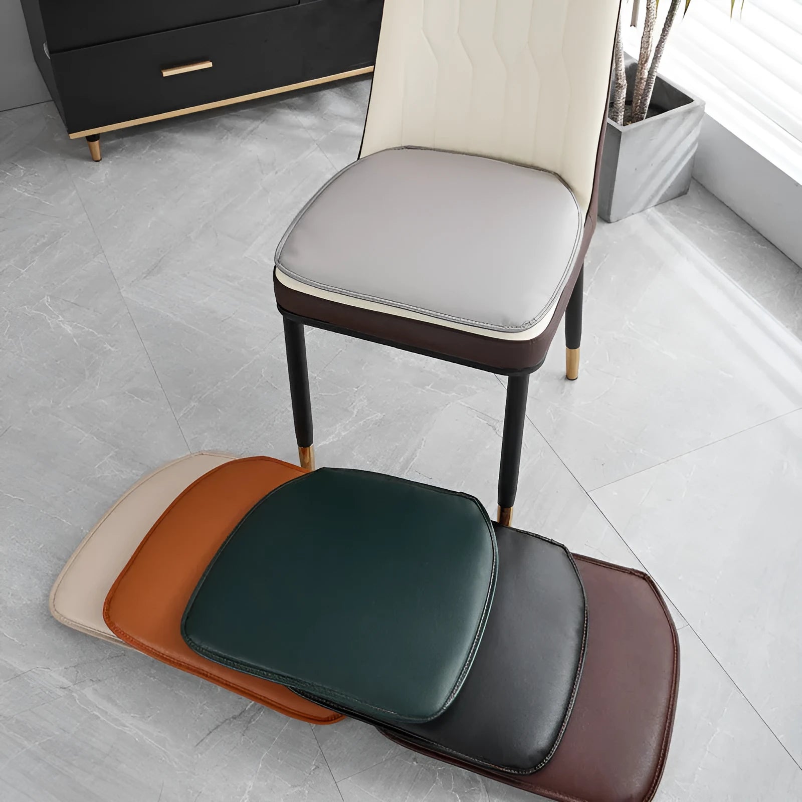 Leather horseshoe-shaped seat cushion on a dining chair, shown in a solid colour with a non-slip base.