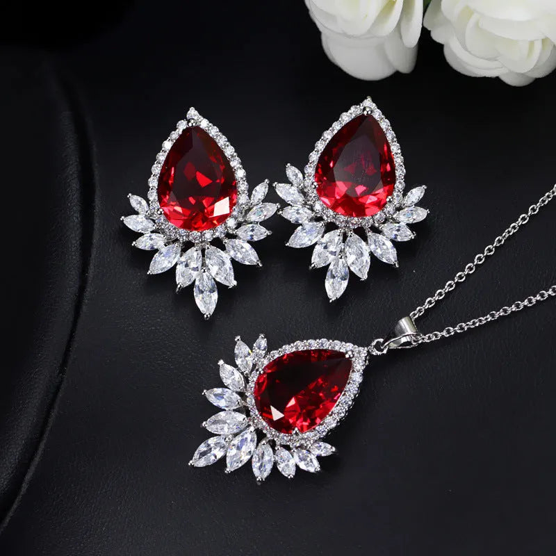AAA formal jewellery set with necklace and earrings featuring cubic zirconia stones and crystal accents in blue, red, or white.