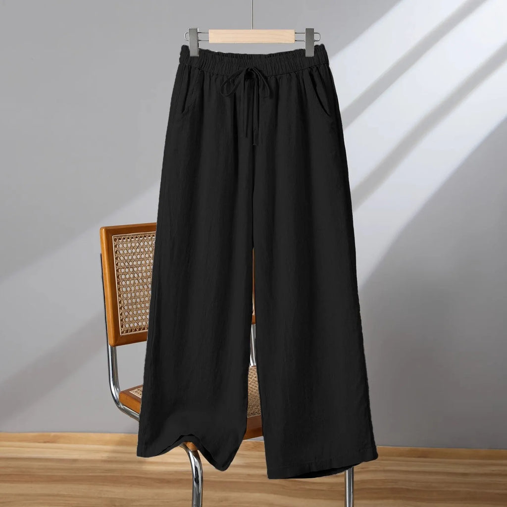 Women's straight-leg casual trousers in apricot colour with elastic waist and lace-up front detail.