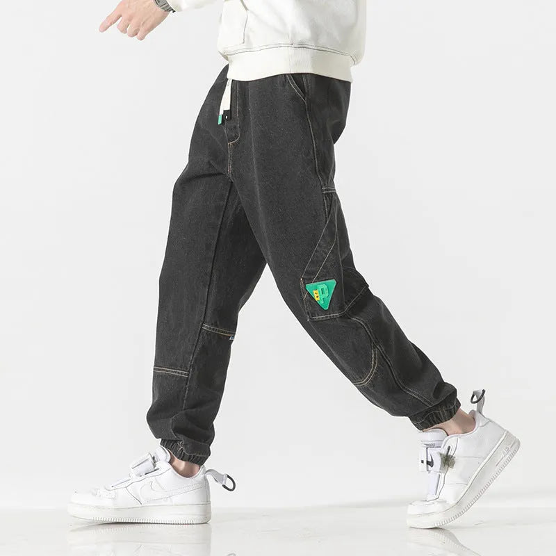 Men's loose-fit tapered trousers in cotton fabric, available in black, blue, and grey colours