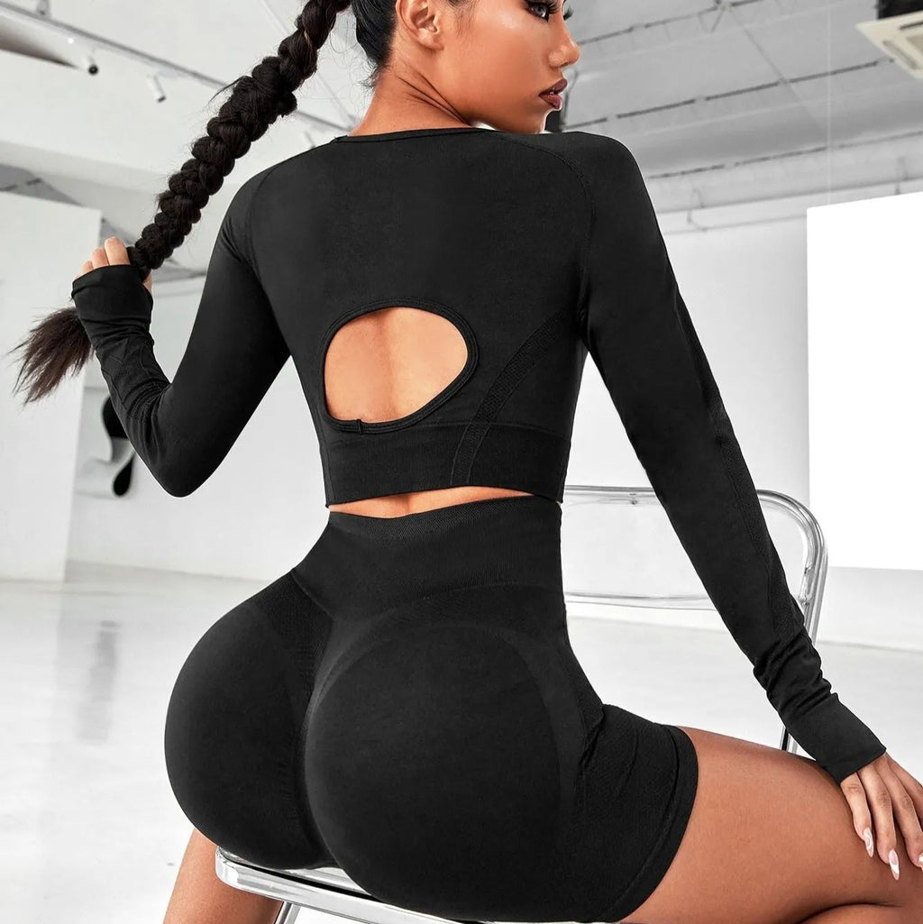 Women's black yoga clothing set with long sleeve top and high-waisted leggings