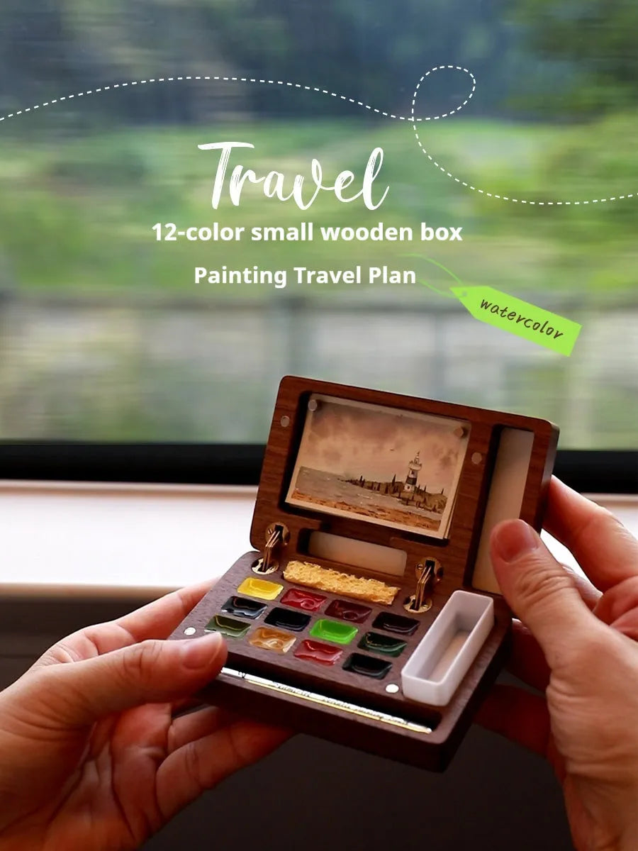 Mini walnut wooden watercolour paint box open to show pigment suit inside
