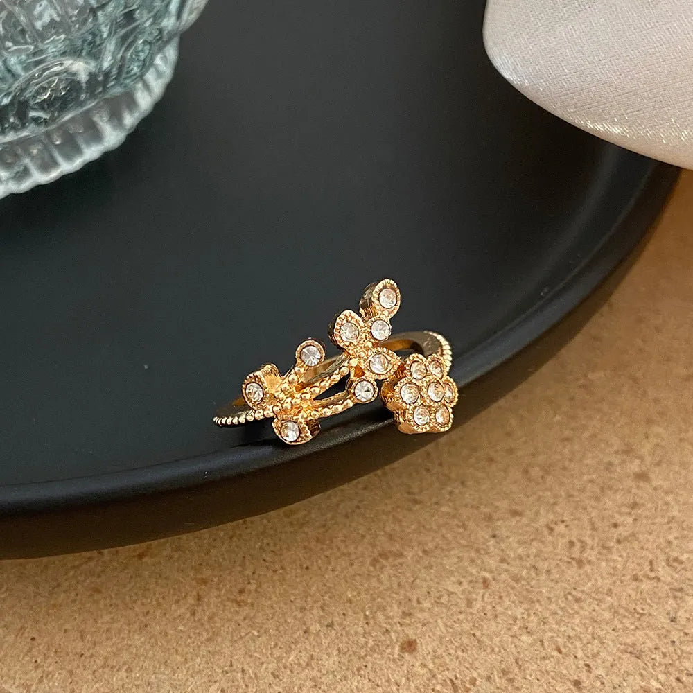 Women's open ring with diamond-cut floral leaf design in gold finish