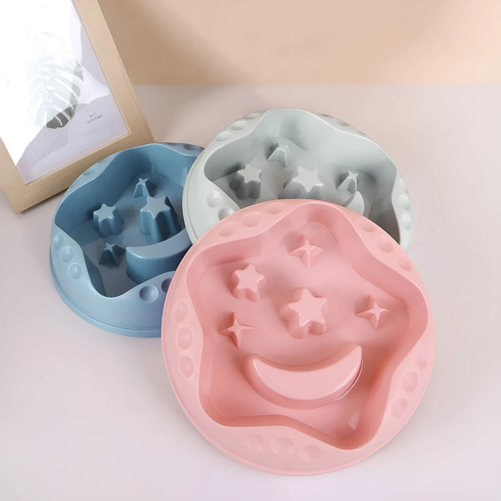 Large blue dog bowl with raised moon and star shapes inside as a slow feeder