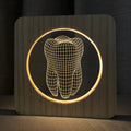 Wood colour tooth-shaped acrylic night light on a surface with USB cable.