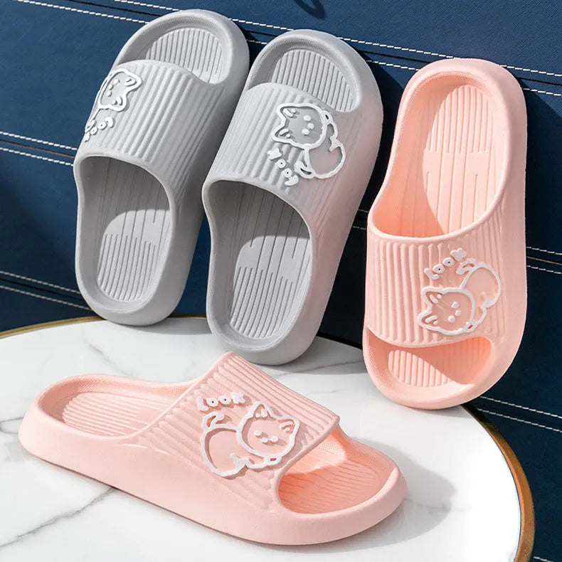 Green cat slippers with a thick EVA platform and non-slip sole on a wooden floor.