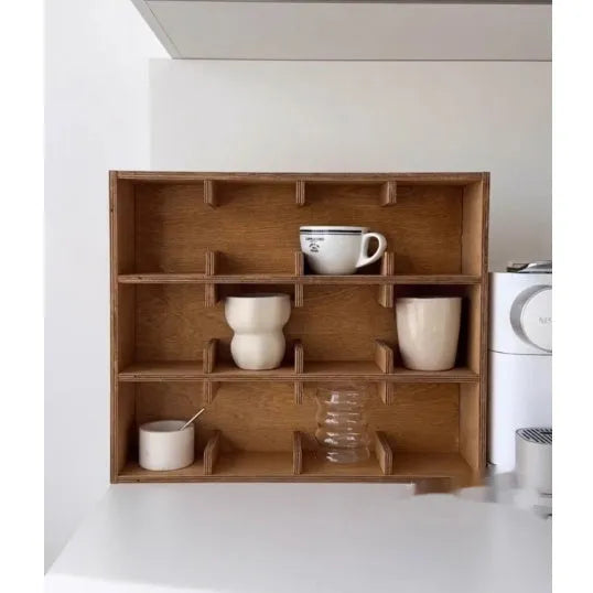 Solid square wood storage rack with multiple grid compartments for cups and mugs in birch wood colour.