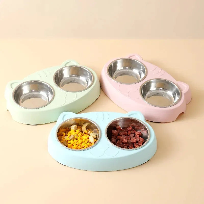 Blue macaron-shaped plastic pet feeder with two separate bowls for food and water.
