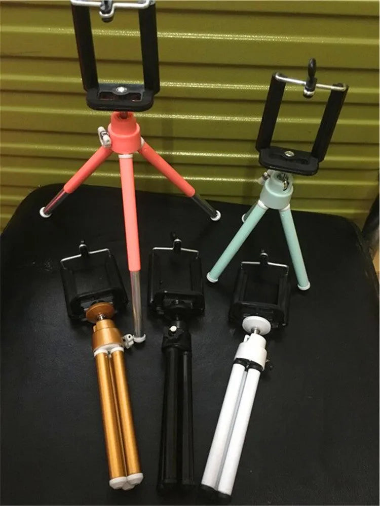 Black desktop phone holder with adjustable two-section bracket and clamp mounting base