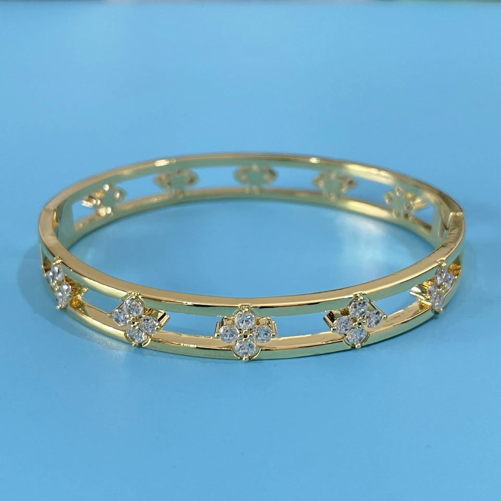 Gold and silver hollow women's bracelets with four-leaf clover charms and zircon stones.