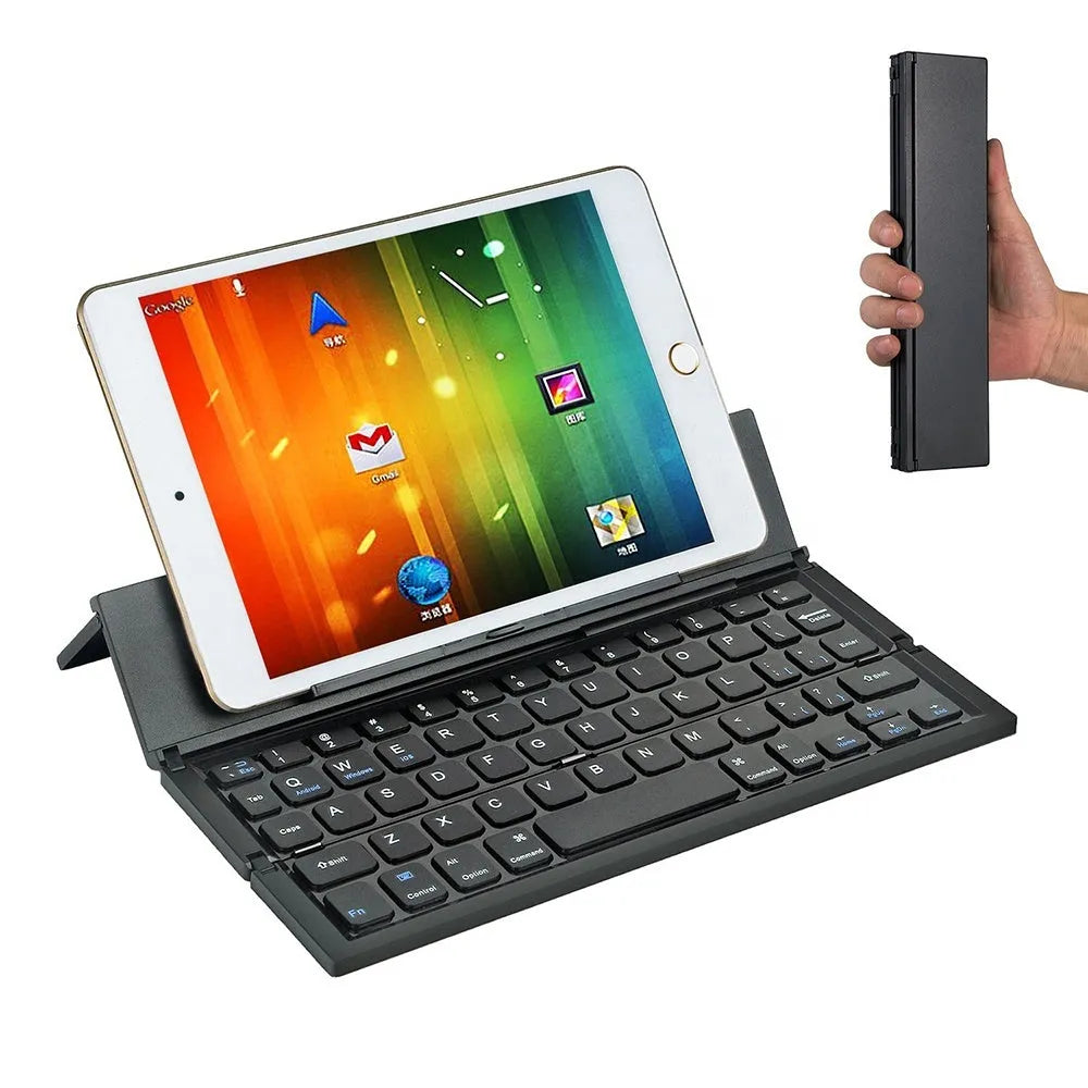 Black foldable ultra-thin wireless Bluetooth keyboard for tablets shown open next to a mobile phone.