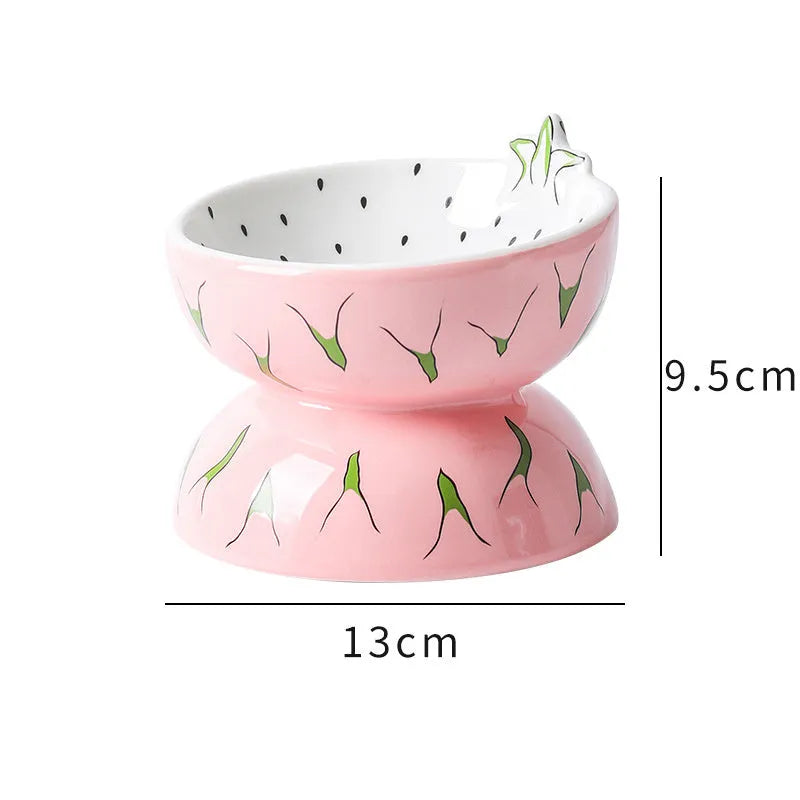 Orange ceramic raised cat bowl with tilted design and non-slip base on a table.