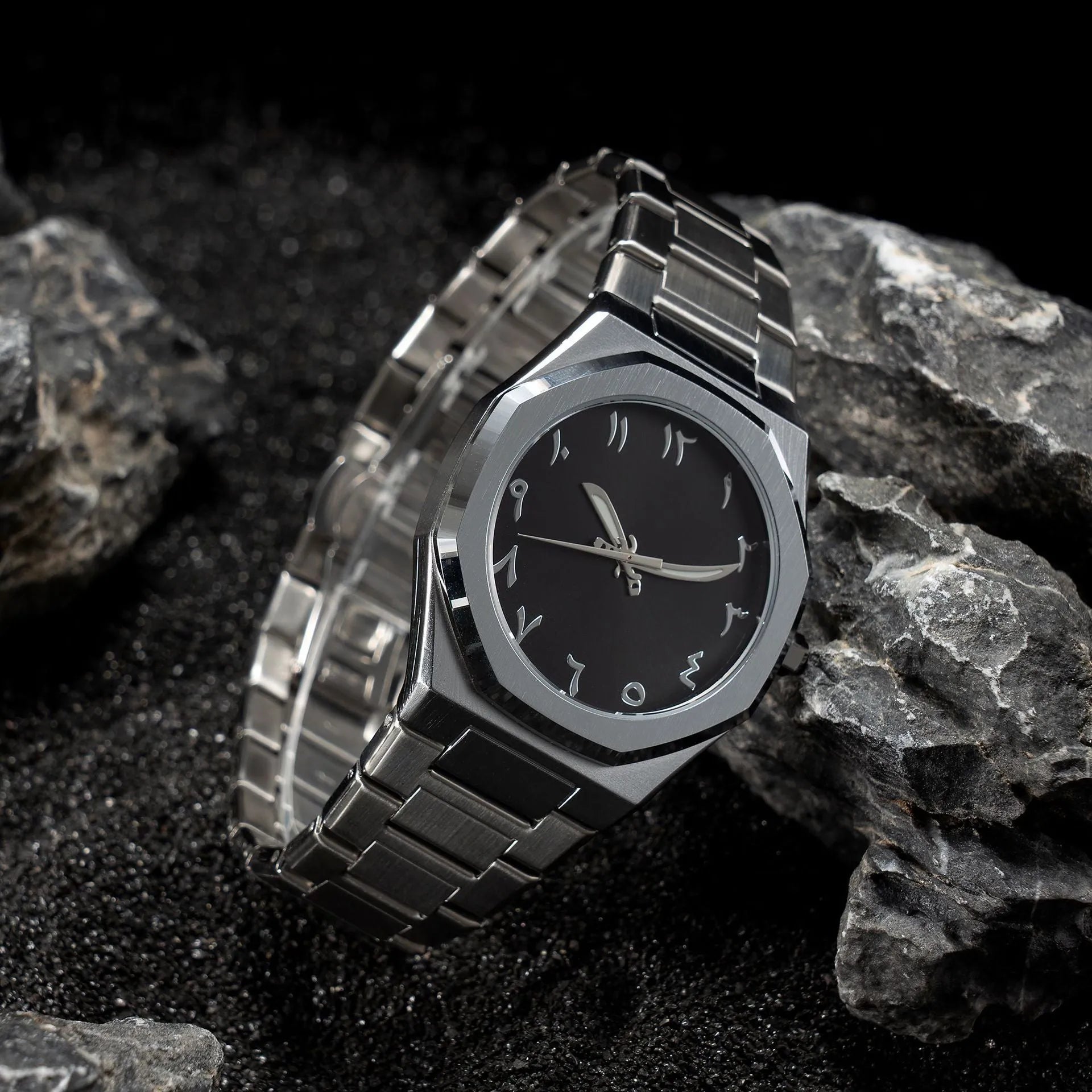 Men's business quartz watch with a steel bracelet and a black and silver dial on a wrist.